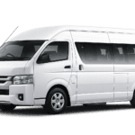 Toyota Hiace Commuter Luxury putih tampak serong depan dan samping untuk layanan sewa Hiace Luxury Jakarta dengan driver profesional